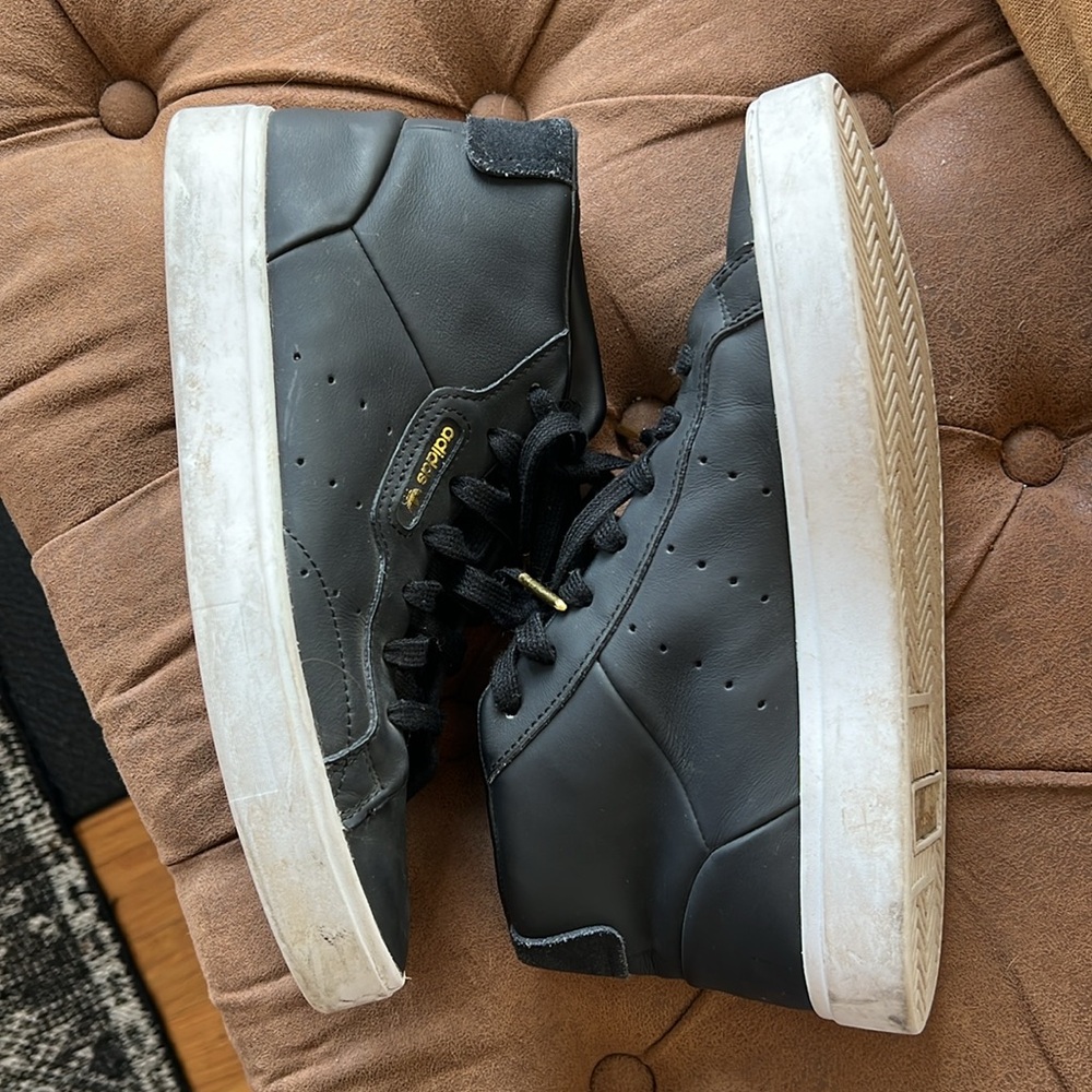 Black High-Top Adidas Sneakers with Gold Accents